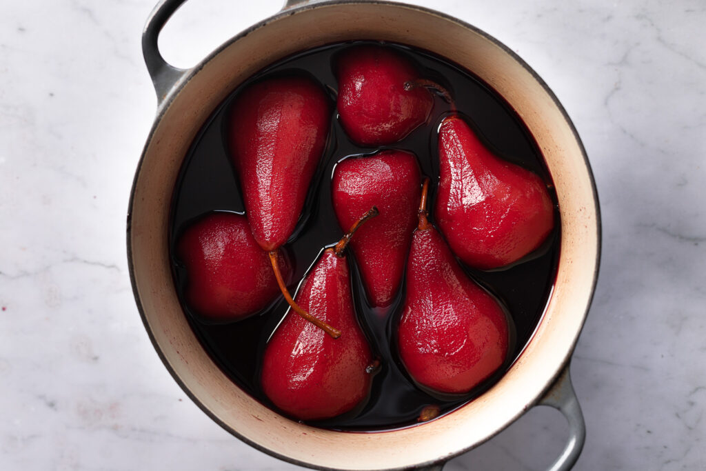 Pears poaching in Cherry Mead